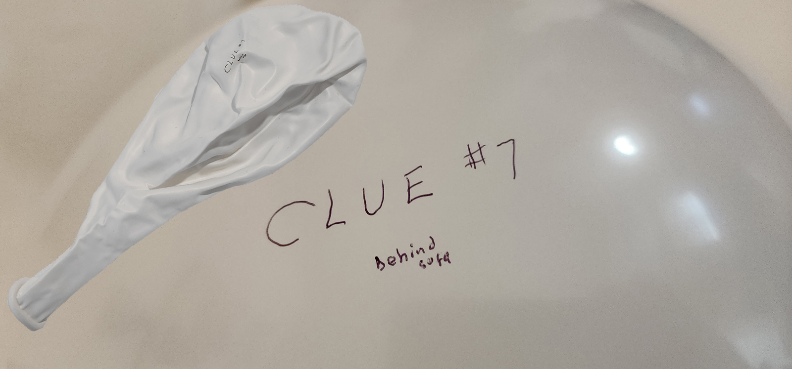 Clue written on inflated balloon with a photo of the same balloon that was shrunken superimposed over the inflated balloon